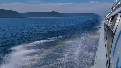 Speeding hydrofoil boat creating beautiful rainbow in wake. 库存影片 334860650