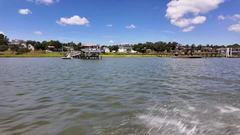 Speeding Past Waterfront Homes on a Summer Morning in Hampstead Stock Footage 346407328