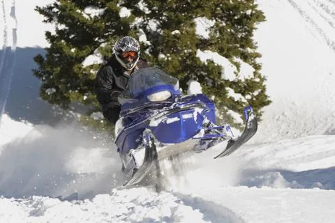 Speeding snowmobile Stock Photos