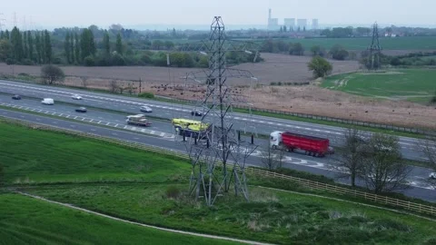 Speeding traffic passing pylon electrici... | Stock Video | Pond5