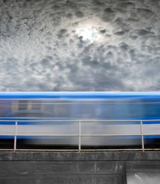 Speeding train, a blurred line under gray skies Stock Photos
