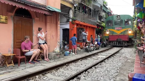 Speeding train coming through famous Train Street, Hanoi, Vietnam, 4K Stock Footage 206496057