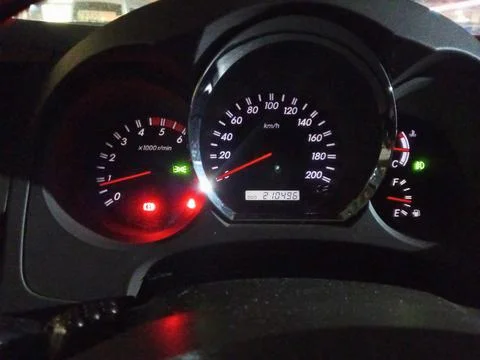 The speedometer glows at night. Stock Photos