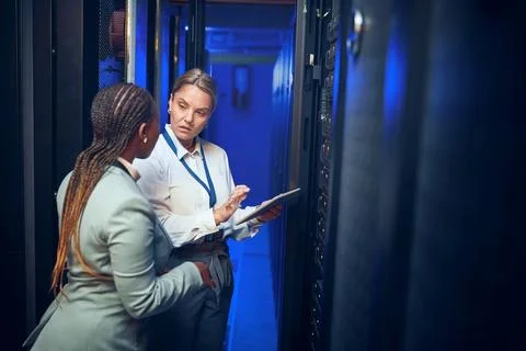 The speeds on this can be improved. two technicians using a digital tablet while Stock Photos