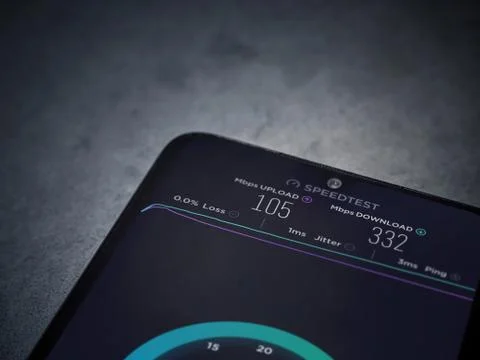Speedtest app launch screen with logo on the display of a black mobile smartp Stock Photos