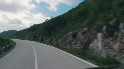 Speedy Driving on a Narrow Road in Mountains Stock Footage 59764040