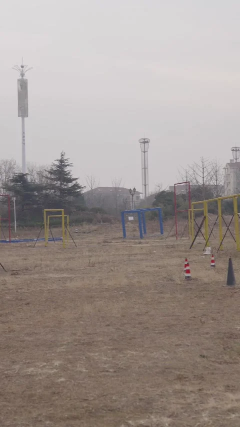 Speedy fpv quadcopter navigating through an outdoor race course with gates and Stock Footage 328987034