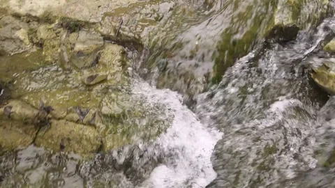 Speedy stream flowing through rocks 스톡 동영상 72503798