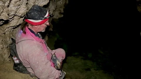 Speleologist take interview about karst cave Stock Footage 70130963