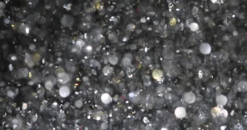 Spellbound vortex of shimmering silver confetti floating in air Stock Footage 321573172