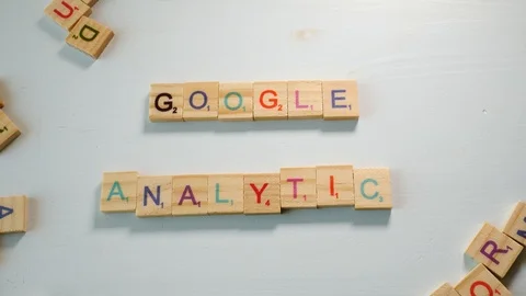 Spelling the sentence Google Analytics with wooden letters on an off white Stock Footage 104411666
