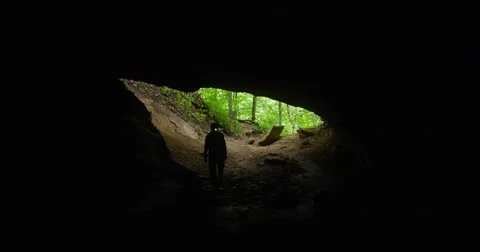 Spelunker Cautiously Enters a Limestone Cave - 4K Stock Footage 71277909