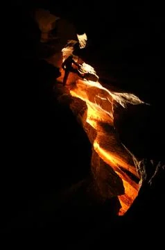 Spelunker exploring a cave Stock Photos