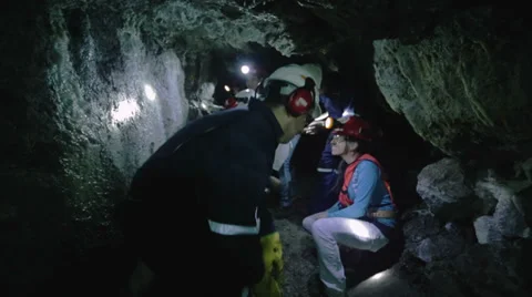 Spelunkers exploring cavern Stock Footage 34900018