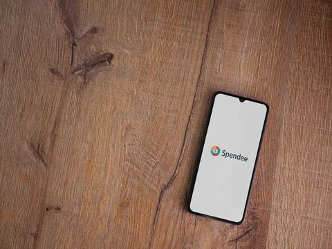 Spendee app launch screen on smartphone on wooden background Stock Photos