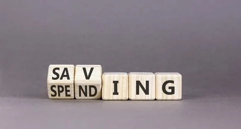Spending and saving symbol. Concept words Saving to Spending on beautiful woo Stock Photos