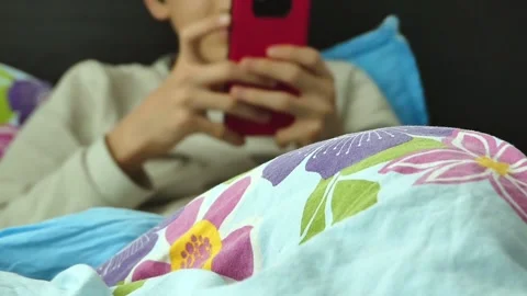 Spending time with cell phone in bed, Stock Footage 166401041