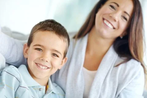 Spending time with mommy. Image of a mother and son smiling at the camera. Stock Photos
