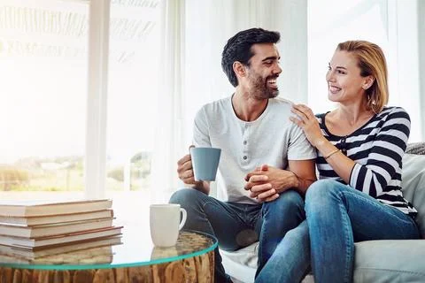 Spending time talking and sharing. an affectionate young couple having coffee Stock Photos