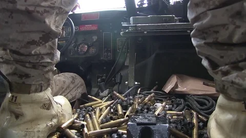 Spent ammunition cases falling inside armoured vehicle during live fire exercise Video stock 91211411