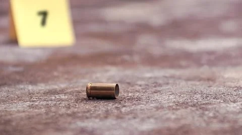 Spent bullet casing lying on the ground with blur number 9 sign. Concepts o.. Stock Photos