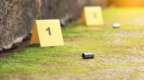 Spent bullet casing lying on the ground with blur number 1 sign. Concepts o.. Foto stock