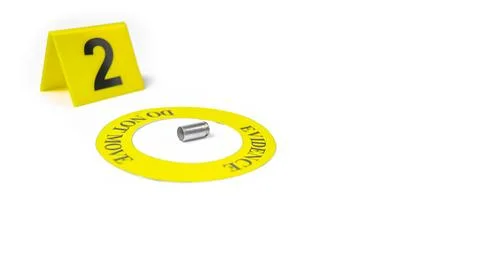 A spent bullet casing placed within a yellow circle, labeled with the text .. Stock Photos