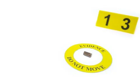 A spent bullet casing placed within a yellow circle, labeled with the text .. Stock Photos