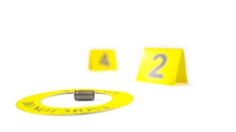 A spent bullet casing placed within a yellow circle, labeled with the text .. Stock Photos