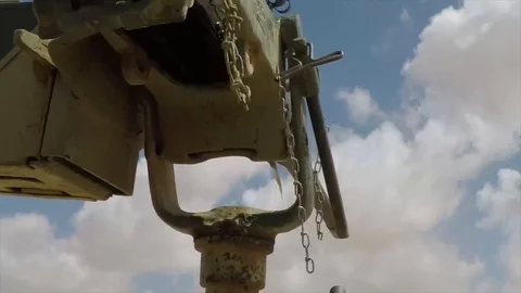 Spent cartridges falling from armored vehicle machine gun in slow motion Stock Footage 105646653