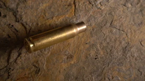 Spent rifle shell falls in slow motion Stock Footage 61815784