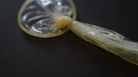 Sperm on a rubber condom. sperm semen on a condom. Stock Footage 236454065