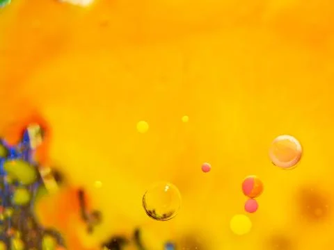 Spheres and multicolour pattern on abstract orange background. Close up macro Stock Photos