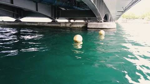 Spherical buoys floating on the waves on the Limmat river in Zurich Stock Footage 132431528