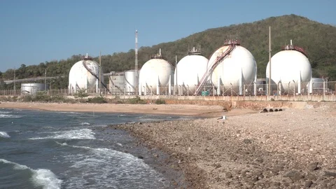 Spherical gas storage tanks in the refinery industry are on the shore with go Stock Footage 108962051
