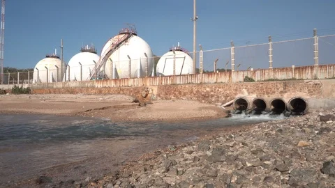 Spherical gas storage tanks in the refinery industry are on the shore with go Stock Footage 108962248