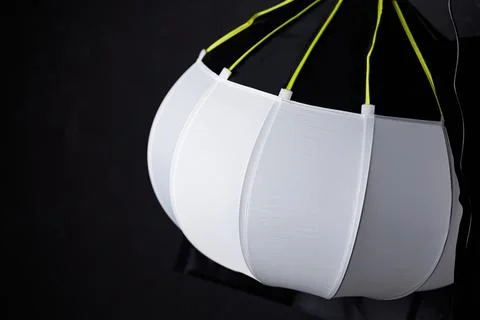 Spherical lantern softbox modifier on a dark studio background. Stock Photos
