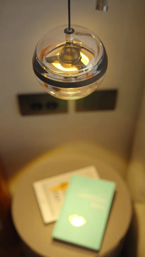 Spherical pendant light above bedside table, Montenegro interior Stock Footage 329412256