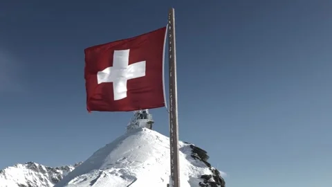 Sphinx Observatory At Top Of Jungfraujoch and Swiss Flag in a Sunny Winter Day Stock Footage 345786357