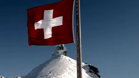 Sphinx Observatory At Top Of Jungfraujoch on Mountain Peak and Swiss Flag in a Stock Footage 303784403