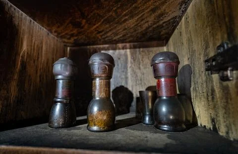 Spice jars stored inside an old cabinet, covered with soot and grime Stock Photos