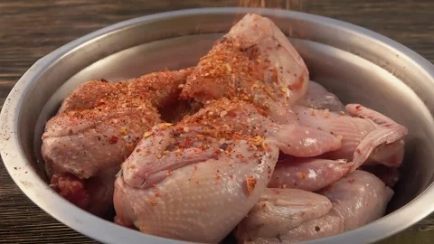 Spice mix is poured on quail Stock Footage 308792253