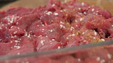 Spice mixture falls to pieces of fresh meat Stock Footage 70858736