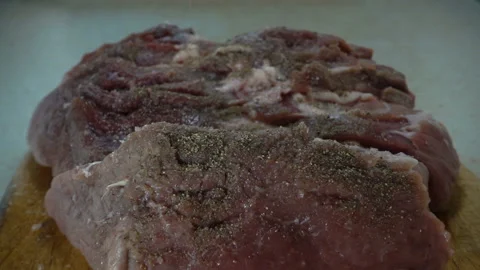 Spice pepper sprinkled in slow motion on a raw meat and hands rub spices Stock Footage 130520783