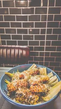 Spice White Corn Ribs grilled over open fire and served in a blue bowl Stock Photos