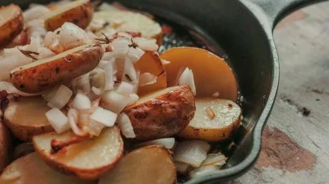 Spiced apple slices baking in a rustic cast iron pan Stock Photos
