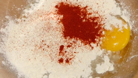 Spices add to plate with egg and flour, slow motion Vidéo 76166331