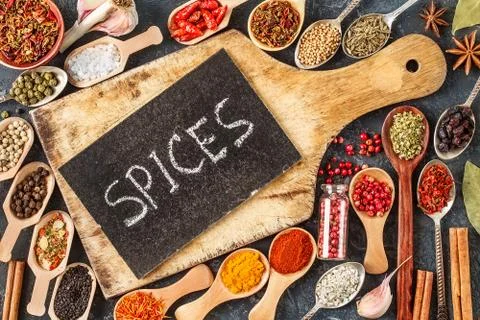 Spices and empty  cutting board on black background Stock Photos