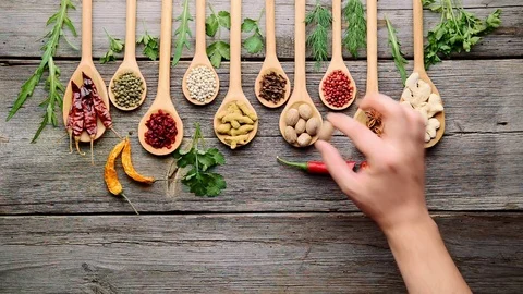 Spices and fresh herbs on a wooden table Stock Footage