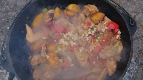 Spices are added to the dish in the cauldron. Shot of adding spices to a dish Stock Footage 284941012